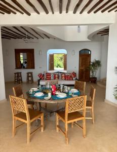 a dining room with a table and chairs at Sea view house in Kilifi