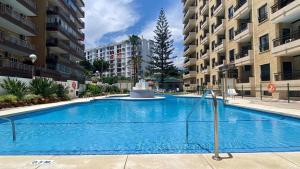 a large swimming pool in the middle of a building at Ronda IV - Best Location Apartment in Las Lagunas Mijas