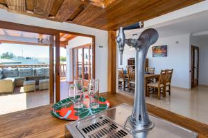 a kitchen with a sink and a table with glasses at Casa Papillon in Playa Blanca