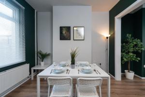 a white dining room with a white table and chairs at Stylish 3Bed House in Hull - sleeps 5 in Hull