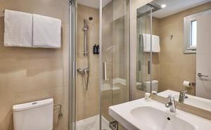 a bathroom with a shower and a toilet and a sink at URH Excelsior in Lloret de Mar
