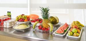 a bunch of fruit on a counter with bowls of fruits at URH Excelsior in Lloret de Mar