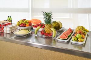 a bunch of fruit on a counter with bowls of fruit at URH Excelsior in Lloret de Mar
