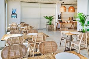 a row of tables and chairs in a restaurant at URH Excelsior in Lloret de Mar