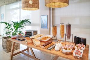 a table with various food items on it at URH Excelsior in Lloret de Mar