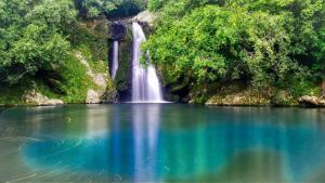 a waterfall in the middle of a body of water at Villa L'arbre du voyageur -Grande piscine privée vue imprenable sur l'Ocean indien in Saint-Leu