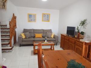 a living room with a couch and a table at Rayos de Sol in Peñíscola +43 photos