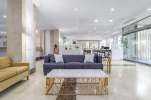 a living room with a couch and a coffee table at Exe Pozuelo in Pozuelo de Alarcón