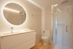 a bathroom with a sink and a toilet and a mirror at Apartaments Edificio Puerto in Colònia de Sant Jordi