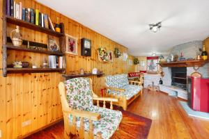 a living room with wood paneled walls and a fireplace at Casa Betulla Champorcher in Champorcher