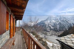 a balcony with a view of a snow covered mountain at Casa Betulla Champorcher in Champorcher