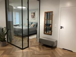 a bedroom with a bed and a mirror in a room at Wilcza City Center Apartments in Gdańsk