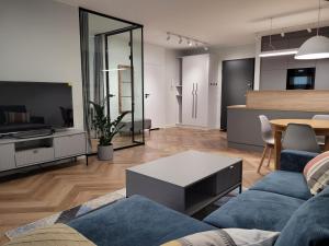 a living room with a couch and a table at Wilcza City Center Apartments in Gdańsk