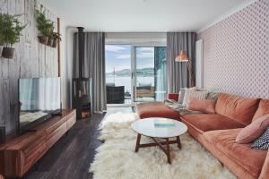 a living room with a couch and a tv at No.26 By The Sea in Oban
