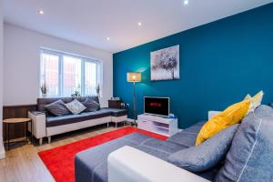 a living room with a couch and a tv at GuestReady - Anfield Urban Escape in Liverpool