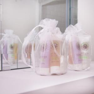 a group of bottles of soap in plastic bags on a shelf at GuestReady - Monochromatic Retreat in Liverpool