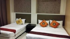 Postel nebo postele na pokoji v ubytování SohoTown Hotel