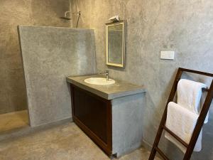 a bathroom with a sink and a mirror at Par 5 Golf Villa in Digana +22 photos