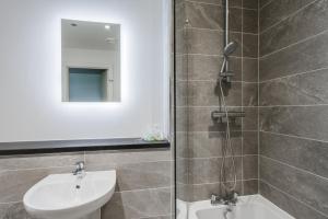 a bathroom with a shower and a sink and a toilet at GuestReady - One perfect resting place in Vauxhall in Liverpool