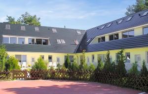 a building with solar panels on its roof at Cozy Apartment In Ostseebad Breege Ot Ju With Kitchen in Drewoldke