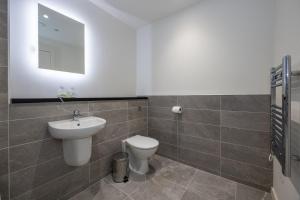a bathroom with a toilet and a sink and a mirror at GuestReady - Liverpool's best near World Museum in Liverpool