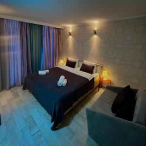 a bedroom with a large bed and a couch at Aparthotel Holiday Lux Batumi in Batumi