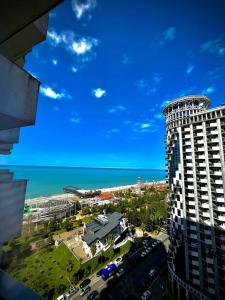 a view of a city and the ocean from a building at Aparthotel Holiday Lux Batumi in Batumi
