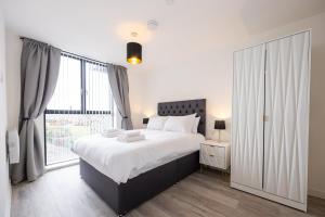 a bedroom with a large bed and a window at GuestReady - Liverpool Adventure near World Museum in Liverpool