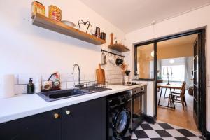 a kitchen with a sink and a dishwasher at GuestReady - Walton's Delight in Liverpool