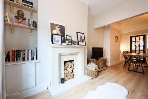 a living room with a fireplace and a table at GuestReady - Walton's Delight in Liverpool