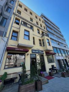 a tall building with tables and chairs in front of it at Galata Dream Hotel in Istanbul