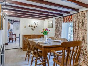 a dining room with a wooden table and chairs at 3 Bed in Newquay 82369 in Mitchell