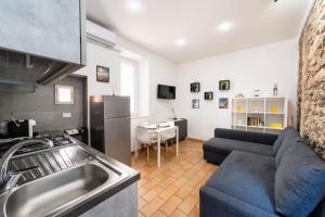 a kitchen and a living room with a couch at Casa Gioia in Terracina