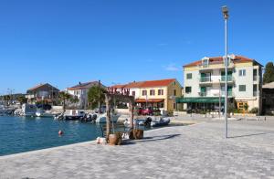 a marina with boats in the water and buildings at Villa Galleria in Sukošan