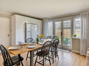 a kitchen and dining room with a wooden table and chairs at 4 Bed in Crosby-on-Eden 94398 in Crosby