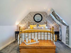 a bedroom with a gold bed and a mirror at 4 Bed in Crosby-on-Eden 94398 in Crosby