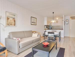 a living room with a couch and a table at Wellington I C5 051 in Wenduine