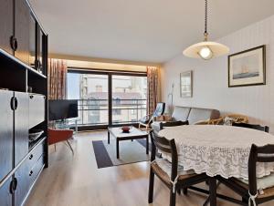 a kitchen and living room with a table and a living room at Wellington I C5 051 in Wenduine