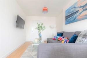 a living room with a couch and a table at Riverside Rendezvous 1 bedroom Near Airport and City Centre SF in Liverpool