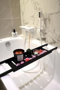 a bathroom with a black shelf on the tub at Stylish home in Warwick with parking & EV charger in Warwick