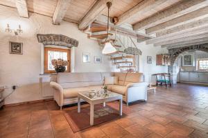 a living room with a couch and a table at Pool Villa Lavanda - Happy Rentals in Šmarje