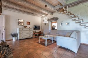 a living room with a couch and a table at Pool Villa Lavanda in Šmarje