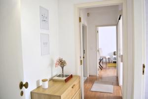 a hallway with a table with a vase on it at Nature et al House - Farmhouse in Batalha