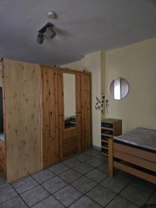 um quarto com um armário de madeira e uma cama em 01 Manuela em Ober-Mörlen