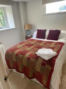 a bedroom with a bed with a quilt on it at Best Beach 2025 "Little Haven" & The Hidden Gem in Haverfordwest