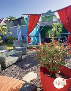 a patio with a table and chairs and plants at Ti Mango Julie in Le Gosier