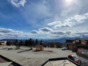 a view of a parking lot with mountains in the background at Studio Saint-Michel-de-Chaillol, 1 pièce, 4 personnes - FR-1-393-57 in Saint-Michel-de-Chaillol