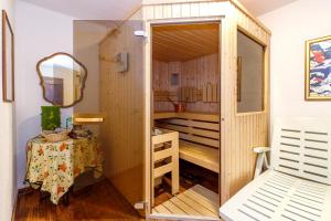 a small bathroom with a shower and a mirror at Villa Formaga Stunning View & Garden - Happy Rentals in Gargnano
