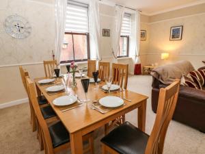 a dining room with a table and a couch at The Old Assembly Rooms in Bishop Auckland