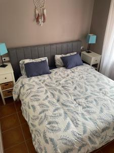 a bedroom with a bed with two blue pillows at Apartementos Almerimar Golf in Almerimar +45 photos